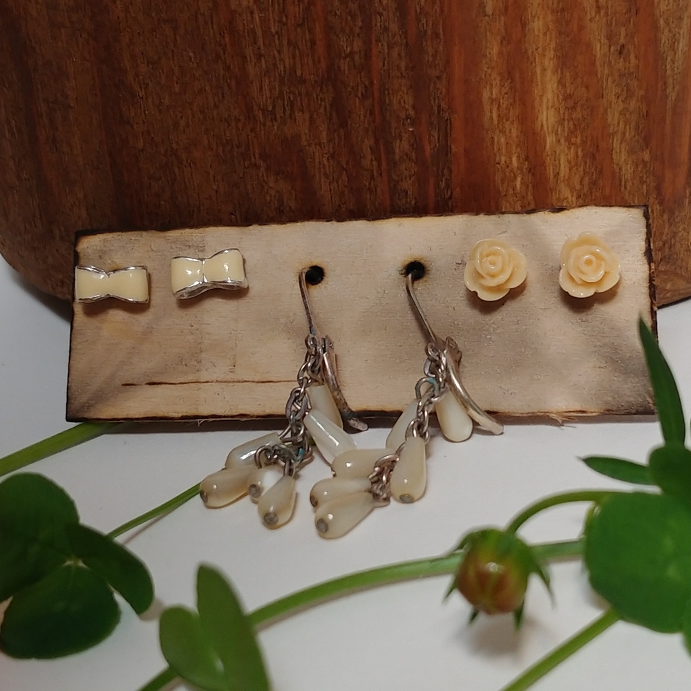 3 pairs of cream and pearl colored earrings